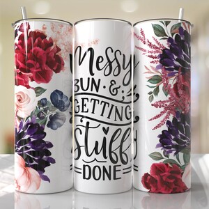 May include: White tumbler with a floral design and the text "Messy Bun & Getting Stuff Done".