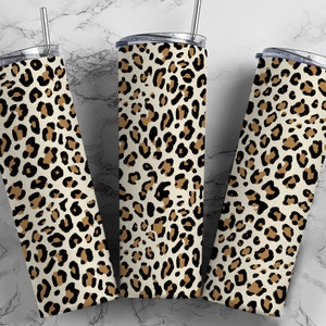 May include: Three stainless steel tumblers with a leopard print design. The tumblers are white with brown and black spots.