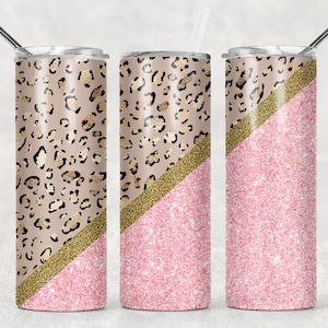 Puede incluir: Un vaso de acero inoxidable con un diseño de purpurina rosa y dorada. La mitad inferior del vaso es de purpurina rosa, y la mitad superior es un estampado de leopardo con detalles dorados.