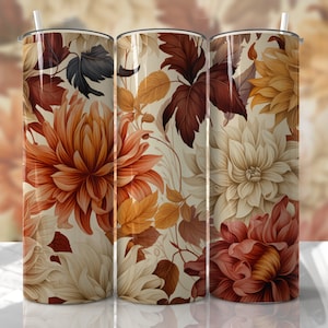 May include: Three stainless steel tumblers with a floral design. The tumblers feature a white background with red, orange, and yellow flowers and leaves.