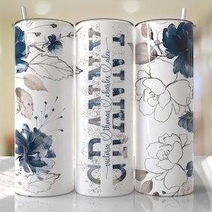May include: A white stainless steel tumbler with a blue and gray floral design. The tumbler has the text "GRATITUDE" in a stylized font with the names "victoria thomas charles alex" written below.