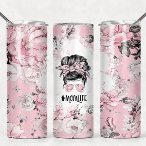 May include: Three stainless steel tumblers with a pink floral design and a black and white illustration of a woman with a messy bun and sunglasses. The text "#MOMLIFE" is printed on the tumbler in the center.