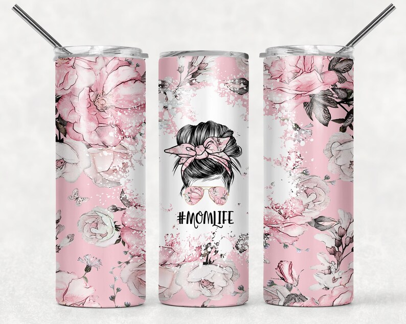 May include: Three stainless steel tumblers with a pink floral design and a black and white illustration of a woman with a messy bun and sunglasses. The text "#MOMLIFE" is printed on the tumbler in the center.