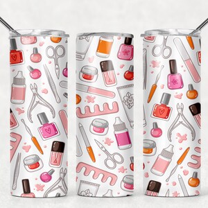 May include: A white stainless steel tumbler with a pink and white pattern of nail polish bottles, nail clippers, nail files, and other manicure tools.