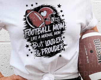 May include: White t-shirt with a black and white graphic design featuring a football and helmet with the text "Football Mom Like a Normal Mom But Louder & Prouder".