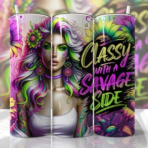 May include: A stainless steel tumbler with a colorful design featuring a woman with green eyes and pink and purple hair. The design also includes sunflowers and the text "Classy with a Savage Side".