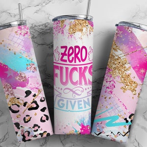 May include: Three stainless steel tumblers with lids and straws. The tumblers feature colorful designs with pink, blue, and gold accents. One tumbler has the text "Zero Fucks Given". The other two have abstract patterns.