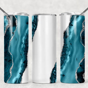 May include: Three stainless steel tumblers with a teal and silver agate design. The tumblers are all the same size and shape, but one is white, one is teal, and one is a combination of the two.