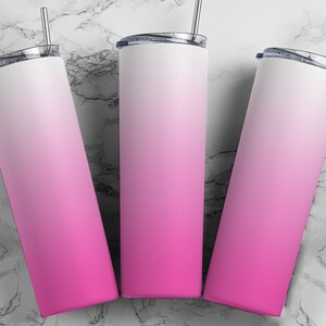 May include: Three stainless steel tumblers with a pink to white ombre design. The tumblers have lids and straws.
