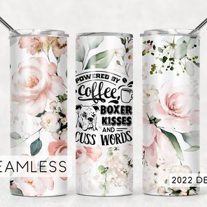 May include: A white tumbler with a floral design and the text "Powered by Coffee, Boxer Kisses and Cuss Words".