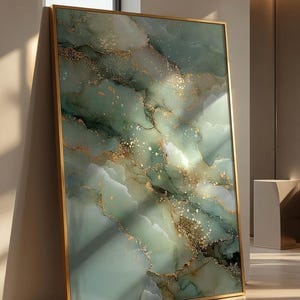 May include: A large rectangular wall art piece featuring an abstract marble-like pattern in shades of sage green, white, and dark forest green. The design is accented with metallic gold veins and speckles, all encased in a thin gold frame.