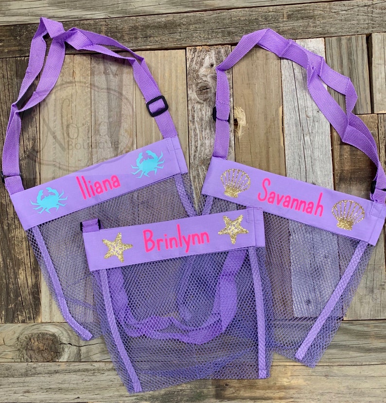 May include: Three purple mesh bags with adjustable straps. Each bag has a different sea creature design and a personalized name: Iliana, Brinlynn, and Savannah.