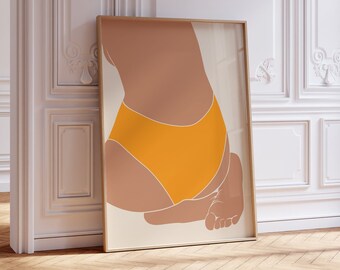 May include: A minimalist art print featuring a stylized illustration of a person wearing orange underwear. The print is framed in a light wood frame and is leaning against a white wall.