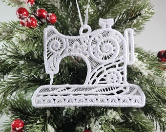 May include: White lace sewing machine Christmas ornament. The ornament is detailed with intricate lacework and has a loop for hanging.