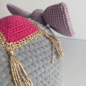 a close up of a knitted hat with a tassel