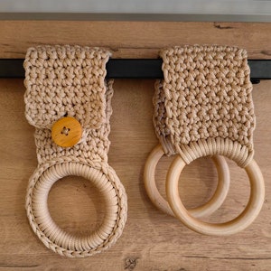 a pair of wooden rings hanging from a wall