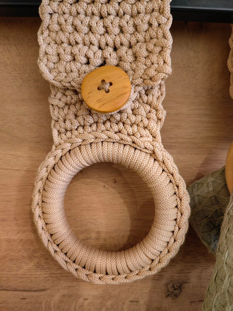 a crocheted object with a wooden button on it