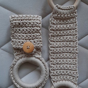 a crocheted bag with a ring and a button on it