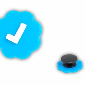 May include: A blue and white check mark sticker with a black pop socket.