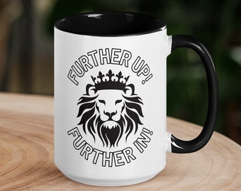 May include: White ceramic mug with a black interior and handle. The mug features a black and white illustration of a lion wearing a crown with the text "Further Up! Further In!"