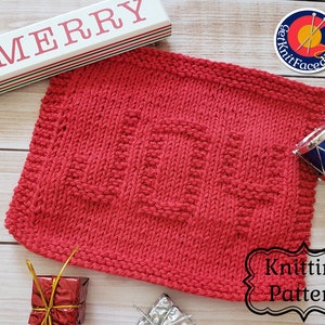 May include: Red knitted dishcloth with a "Home" design. The dishcloth is on a wooden surface with a sign that says "Be Merry" and other Christmas decorations.