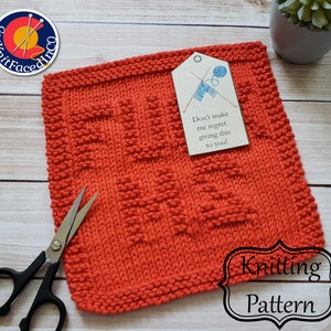 May include: A bright orange knitted dishcloth with a tag that reads "Don't make me regret giving this to you!" The dishcloth is made with a textured stitch pattern.