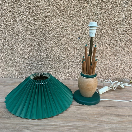 Vintage Beautiful shops table lamp with pencil decorations in light solid wood with dark green pleated fabric shade