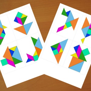 May include: Two sheets of paper with colorful tangram puzzles. Each sheet displays four different tangram designs, including birds and abstract shapes. The puzzles are composed of geometric shapes in various colors like blue, orange, green, and pink.