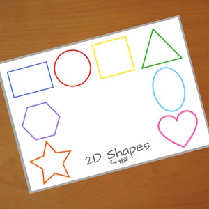 May include: A white sheet of paper with the words "2D Shapes" written in black. There are seven different coloured shapes drawn on the paper: a blue rectangle, a red circle, a yellow square, a green triangle, a blue oval, a pink heart, and an orange star.
