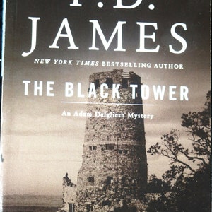 May include: Book cover for "The Black Tower" by P.D. James, a New York Times bestselling author. The cover features a black and white photo of a stone tower against a cloudy sky. The text "An Adam Dalgliesh Mystery" is printed below the title.