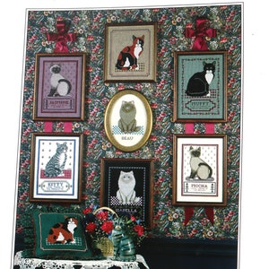 May include: A cross-stitch pattern booklet featuring a collection of cat designs. The cover shows a variety of cats in different poses, including a tabby cat, a Siamese cat, and a calico cat. The title of the booklet is "Loyal Friends - Cats".
