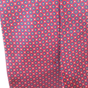 May include: A red silk tie with a repeating pattern of blue and orange flowers on a white background.
