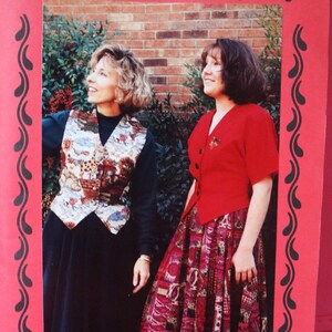 May include: A sewing pattern cover featuring two women wearing garments. The cover is framed in red with black decorative accents. Text on the cover reads "THE HOURGLASS JACKET & VEST" and "The Perfect Companion for the 'Hourglass Skirt and 'Ninety's Swirl Skirt".