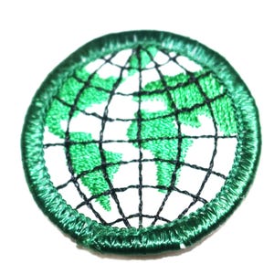 May include: Green embroidered patch with a white globe design. The globe has a black grid pattern and green continents.