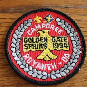 May include: Red, white, and black embroidered patch with a yellow eagle and the text "Campore Golden Gate Spring 1994 Royaneh - OA".