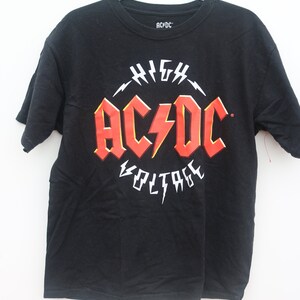 May include: Black t-shirt with a red and white AC/DC logo that says "High Voltage".