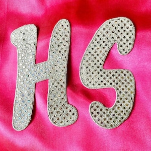 May include: A trio of ceramic mugs with a speckled, matte finish in cream, light grey, and dark grey. Each mug features a simple, minimalist design, ideal for tea or coffee.