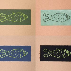 Fish patches in the colours Forest, Sea Green, Blue, and Black.