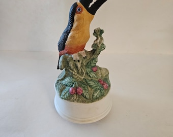 Toucan bird rotates plays oh what a beautiful morning