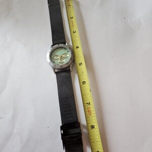 Ladies green face watch with new battery image 4