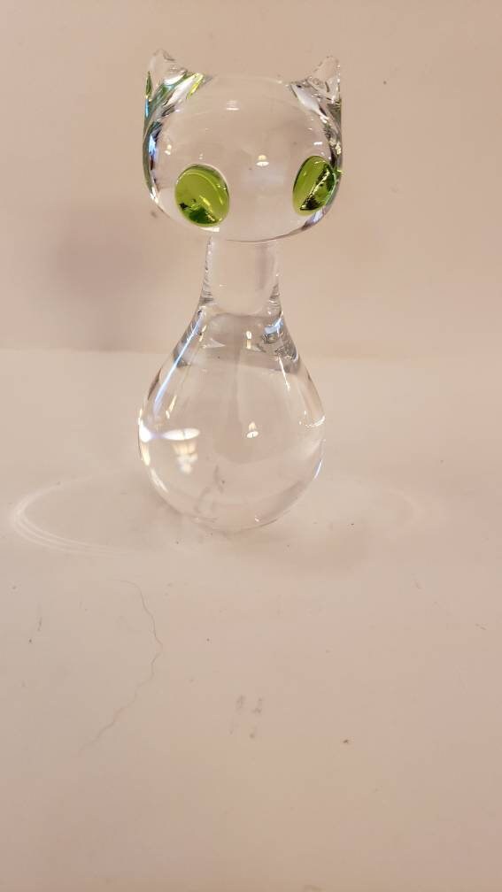 Glass cat with green eyes