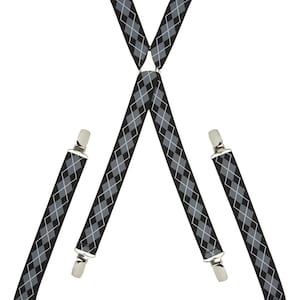 May include: Black and gray patterned suspenders with silver clips. The suspenders are made of a woven fabric and have a diamond pattern.