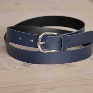 May include: A dark blue leather belt with a silver buckle.