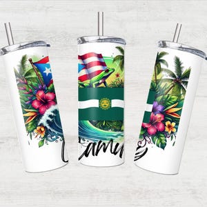 May include: Three white stainless steel tumblers with lids and straws. Each tumbler features a different design with a tropical theme. One tumbler has a green frog, another has a palm tree, and the third has a flower and wave design. All tumblers have a green, white, and red flag with a star.