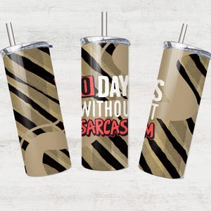 May include: Three stainless steel tumblers with lids and straws. The tumblers have a tan and black striped pattern with a tan accent. One tumbler has the text "0 Days Without Sarcasm" in pink and white.