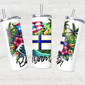 May include: Three stainless steel tumblers with colourful designs. The tumblers feature tropical flowers, a green frog, and a blue and yellow flag. The tumblers are all white with a black outline.
