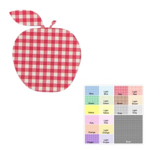 May include: An apple-shaped placemat with a red and white checkered pattern. The placemat has a leaf and stem detail. A color chart is in the lower right corner.