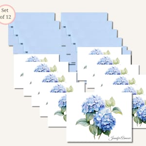 May include: A set of 12 stationery cards and envelopes. The cards feature a watercolor painting of blue hydrangeas with green leaves. The envelopes are light blue. The text "Jennifer Armour" is printed on the cards.