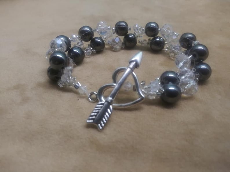 Bracelet 6 strand black hematite and crystal with arrow an heart toggle clasp.