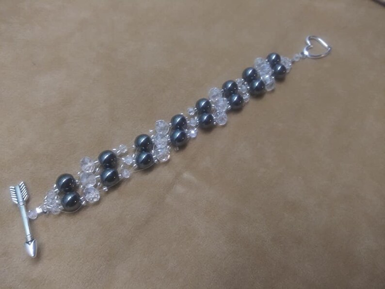 Bracelet 6 strand black hematite and crystal with arrow an heart toggle clasp.
